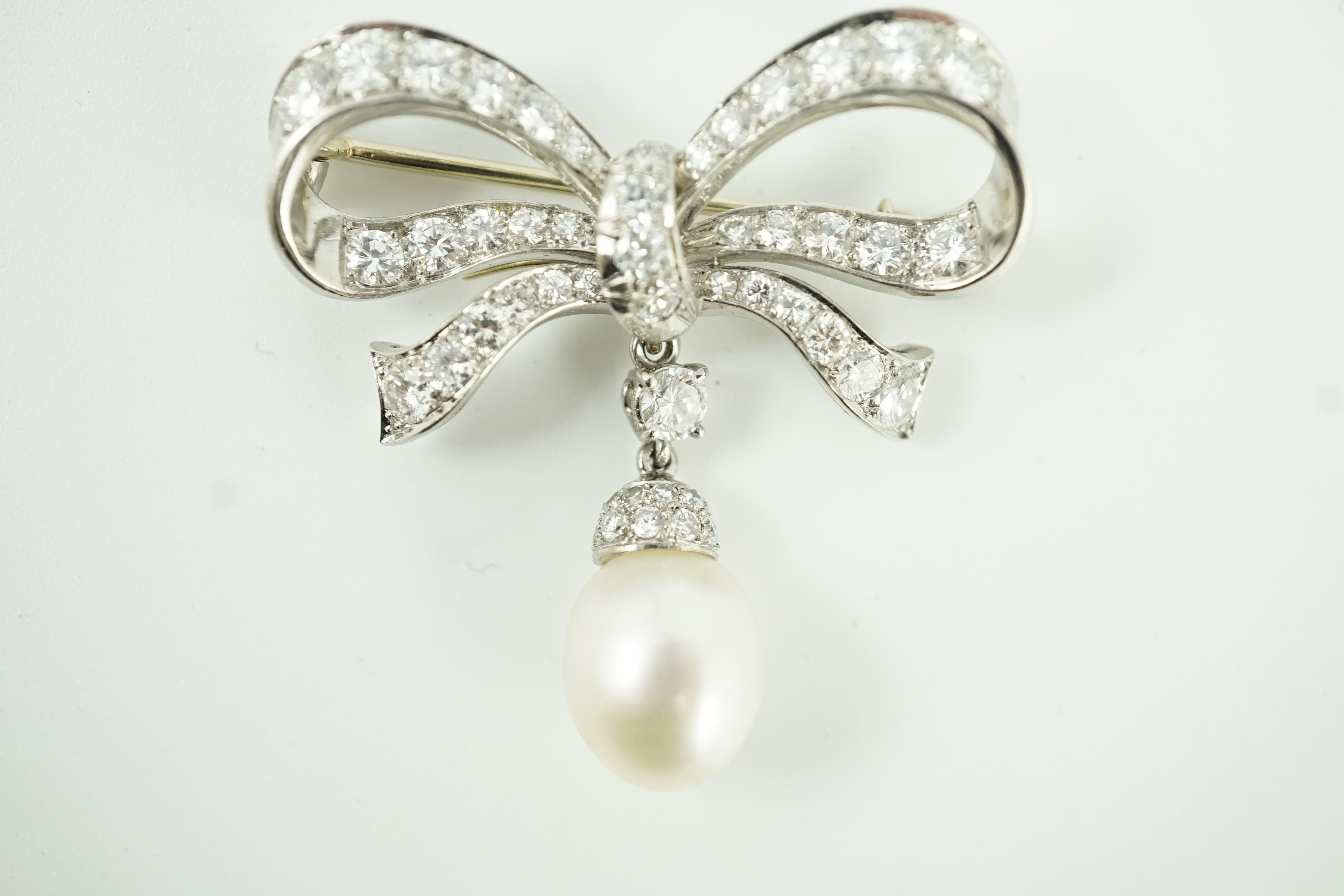 A late 20th century white gold, diamond cluster and single cultured pearl drop set ribbon bow brooch